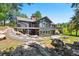 Modern two-story home with large windows and balconies overlooking a beautifully landscaped yard at 1555 Genesee Ridge Rd, Golden, CO 80401