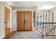 Inviting foyer features hardwood floors, wooden double doors, and a staircase with iron railings at 1555 Genesee Ridge Rd, Golden, CO 80401
