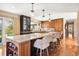 Kitchen island with breakfast bar, open floor plan, and gorgeous wood floors at 1555 Genesee Ridge Rd, Golden, CO 80401