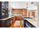 Bright kitchen with light granite counter, wooden cabinets, and stainless steel appliances at 1555 Genesee Ridge Rd, Golden, CO 80401