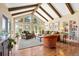 Bright living room with vaulted ceilings, exposed beams, large windows, and hardwood floors at 1555 Genesee Ridge Rd, Golden, CO 80401