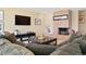 Cozy living room featuring a stone fireplace and comfortable seating area at 1555 Genesee Ridge Rd, Golden, CO 80401