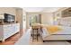 Comfortable main bedroom features a seating area, walk-out balcony, hardwood floors, and a charming dresser at 1555 Genesee Ridge Rd, Golden, CO 80401
