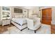 Cozy main bedroom with natural light, seating, wood floors, and built-in storage cabinets for convenience at 1555 Genesee Ridge Rd, Golden, CO 80401
