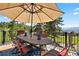 Outdoor patio area featuring a table, chairs and a great view of the mountains and surrounding landscape at 1555 Genesee Ridge Rd, Golden, CO 80401