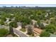 An aerial view of houses with green trees and glimpse of the skyline in the distance at 9939 E Aberdeen Ave, Englewood, CO 80111