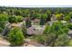Neighborhood aerial view with lush greenery, mature trees, and varied rooflines at 9939 E Aberdeen Ave, Englewood, CO 80111
