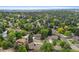 An aerial view showcases the neighborhood's tree-lined streets and well-maintained homes at 9939 E Aberdeen Ave, Englewood, CO 80111