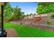The backyard features a retaining wall, terraced garden, and stone steps, creating a peaceful outdoor retreat at 9939 E Aberdeen Ave, Englewood, CO 80111