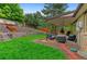 Spacious yard with a covered patio with comfortable outdoor seating, offering an ideal relaxation and entertainment area at 9939 E Aberdeen Ave, Englewood, CO 80111