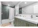 Bathroom with a double sink vanity, subway tile shower, and modern fixtures at 9939 E Aberdeen Ave, Englewood, CO 80111