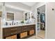 This is a bathroom featuring a double sink vanity, a walk-in closet, and ample storage at 9939 E Aberdeen Ave, Englewood, CO 80111