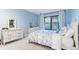 Bright bedroom with white furniture, blue walls, and a sunny window with frilly curtains at 9939 E Aberdeen Ave, Englewood, CO 80111