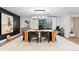 Formal dining room with natural light, a modern chandelier, and a spacious table for entertaining at 9939 E Aberdeen Ave, Englewood, CO 80111