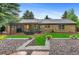The home has a covered patio area that includes outdoor seating, and a well-manicured lawn at 9939 E Aberdeen Ave, Englewood, CO 80111