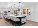 Bright kitchen with white cabinetry, stainless steel appliances, and a large island with bar seating at 9939 E Aberdeen Ave, Englewood, CO 80111