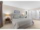 This main bedroom features plush carpeting, neutral walls, and an organized walk-in closet at 9939 E Aberdeen Ave, Englewood, CO 80111