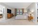 This main bedroom offers lots of natural light, plush carpet, and a dresser and nightstand at 9939 E Aberdeen Ave, Englewood, CO 80111