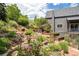 The lush backyard has a garden with a variety of plants and a patio at 14150 Foothill Ln, Golden, CO 80401