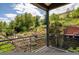 Balcony view shows the beautifully landscaped backyard with mature trees at 14150 Foothill Ln, Golden, CO 80401