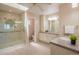 Bright bathroom with dual sinks, walk-in shower, and skylight at 14150 Foothill Ln, Golden, CO 80401