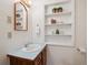 Bright bathroom with wooden vanity and shelf at 14150 Foothill Ln, Golden, CO 80401