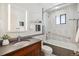 Updated bathroom featuring a gray countertop, white and gray tiled shower and tub, and modern lighting at 14150 Foothill Ln, Golden, CO 80401