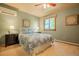 Cozy bedroom with a ceiling fan, light green walls and a window offering natural light at 14150 Foothill Ln, Golden, CO 80401