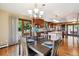 Dining room area with view into the kitchen, featuring wood table, island, and a sliding glass door at 14150 Foothill Ln, Golden, CO 80401
