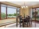 Sunny dining room featuring hardwood floors, large window with scenic view, and stylish chandelier at 14150 Foothill Ln, Golden, CO 80401