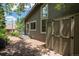 Exterior shot shows the side of the home with stone patio, yard and a storage shed at 14150 Foothill Ln, Golden, CO 80401