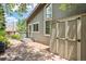 View of the home's exterior with storage shed and a stone patio at 14150 Foothill Ln, Golden, CO 80401