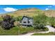 Stunning two-story home with modern architecture and lush landscaping on a hillside setting at 14150 Foothill Ln, Golden, CO 80401