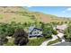 Aerial view of modern home with lush landscaping and a winding driveway at 14150 Foothill Ln, Golden, CO 80401