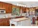Well-appointed kitchen featuring wood cabinets, granite counters, an island and modern appliances at 14150 Foothill Ln, Golden, CO 80401