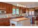 Spacious kitchen featuring granite countertops, wood cabinetry, a center island, and stainless steel appliances at 14150 Foothill Ln, Golden, CO 80401