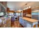 Chef's kitchen with two islands, granite counters, stainless appliances, and hardwood floors at 14150 Foothill Ln, Golden, CO 80401