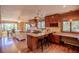 Open floor plan with breakfast bar, island, granite countertops, stainless steel appliances, and hardwood floors at 14150 Foothill Ln, Golden, CO 80401