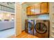 Laundry room with washer, dryer, storage cabinets, and hardwood floors at 14150 Foothill Ln, Golden, CO 80401