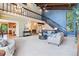 Bright living room with high ceilings, a brick fireplace, and comfortable sofas at 14150 Foothill Ln, Golden, CO 80401