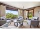 Bright living room with view of wooded yard and access to patio at 14150 Foothill Ln, Golden, CO 80401