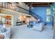 Open-concept living room with fireplace, staircase, and modern furnishings at 14150 Foothill Ln, Golden, CO 80401