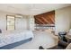 Bright main bedroom with a view, ceiling fan, sitting area, and ensuite bathroom at 14150 Foothill Ln, Golden, CO 80401