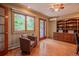 Comfortable office with built-in shelves, wood floors, and access to outdoor space at 14150 Foothill Ln, Golden, CO 80401