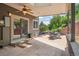 Covered patio with stone flooring, outdoor dining, and lush landscaping at 14150 Foothill Ln, Golden, CO 80401