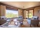 Comfortable sun room with comfortable seating and large sliding glass doors to the exterior at 14150 Foothill Ln, Golden, CO 80401