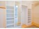 Spacious walk-in closet with built-in shelving and wood floors, and mirrored wall at 14150 Foothill Ln, Golden, CO 80401