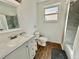 Bright bathroom featuring modern fixtures, wood-look flooring, a granite vanity, and a shower with stone tile at 6800 E Tennessee Ave # 351, Denver, CO 80224