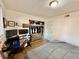 Bright bedroom featuring a work station, open closet with a dresser, and a comfortable bed with gray bedding at 6800 E Tennessee Ave # 351, Denver, CO 80224