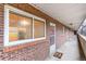 Exterior shot of unit 331 with a brick facade, window, and door at 6800 E Tennessee Ave # 351, Denver, CO 80224